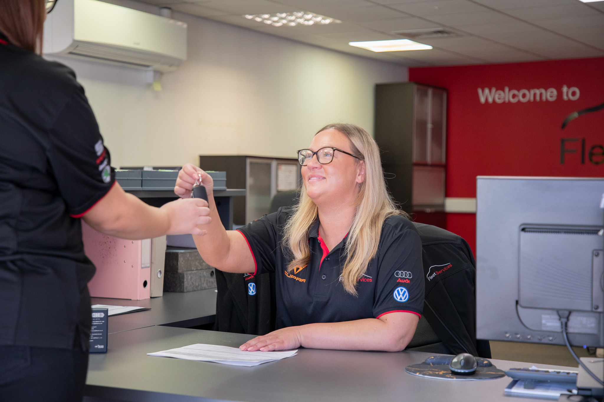 Receptionist handing over vehicle keys.