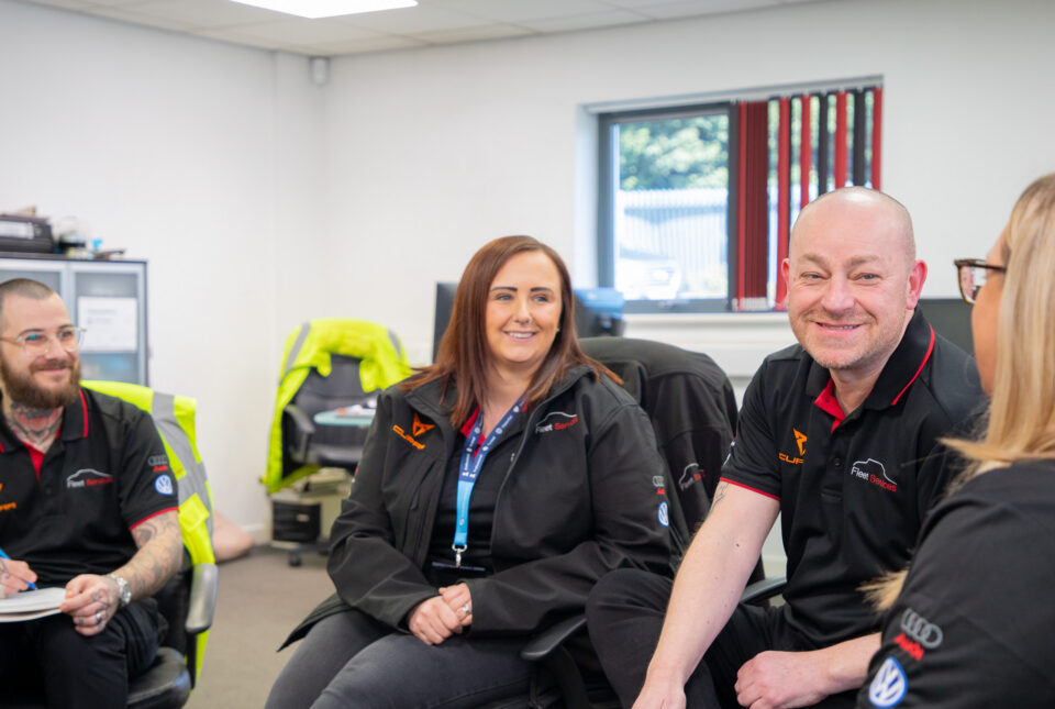 Employees smiling during a team meeting
