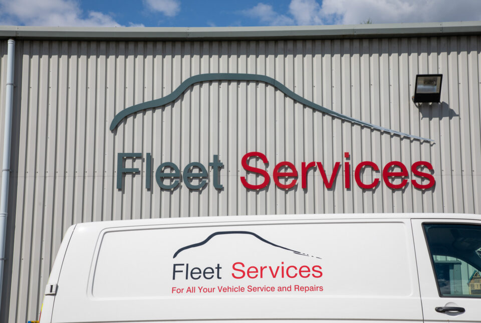 Fleet services building and van signage